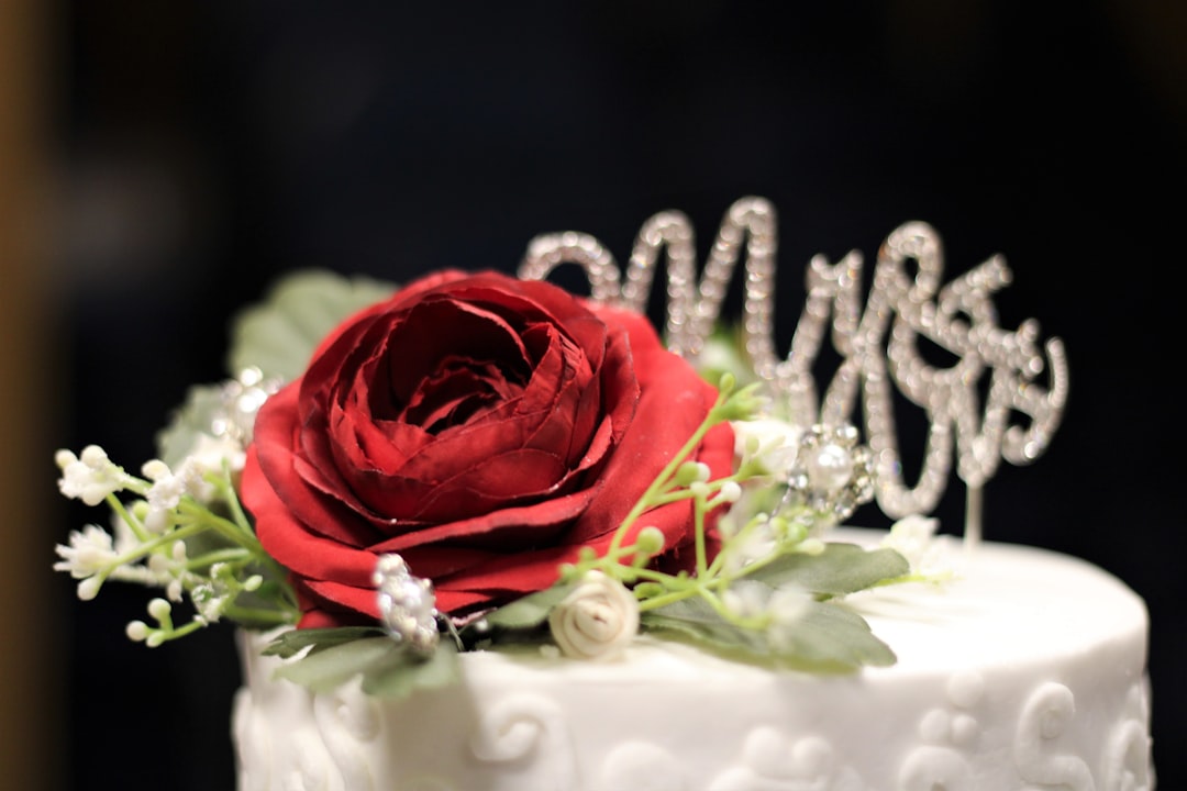 a-close-up-of-a-cake-with-a-red-rose-on-top-oumov-w2s98